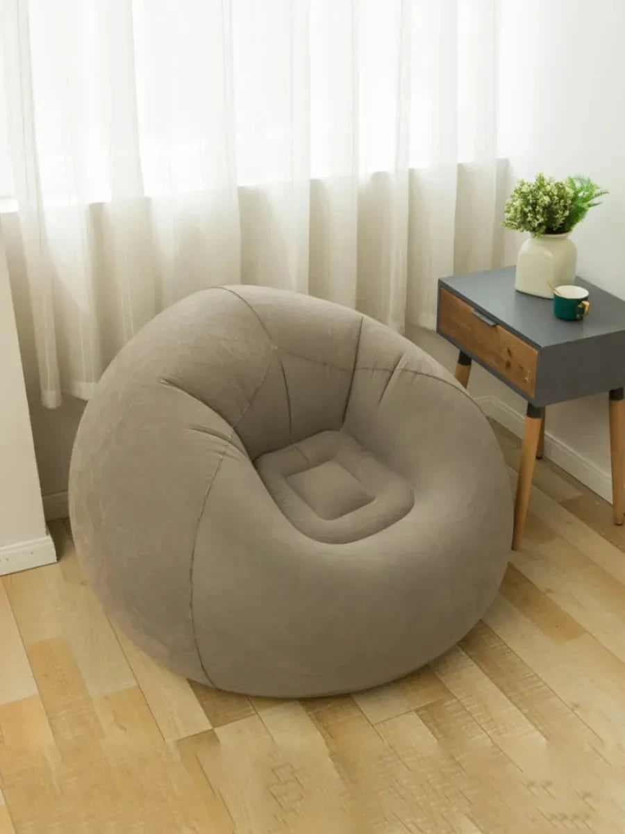 Taupe gray inflatable lazy sofa next to a small side table