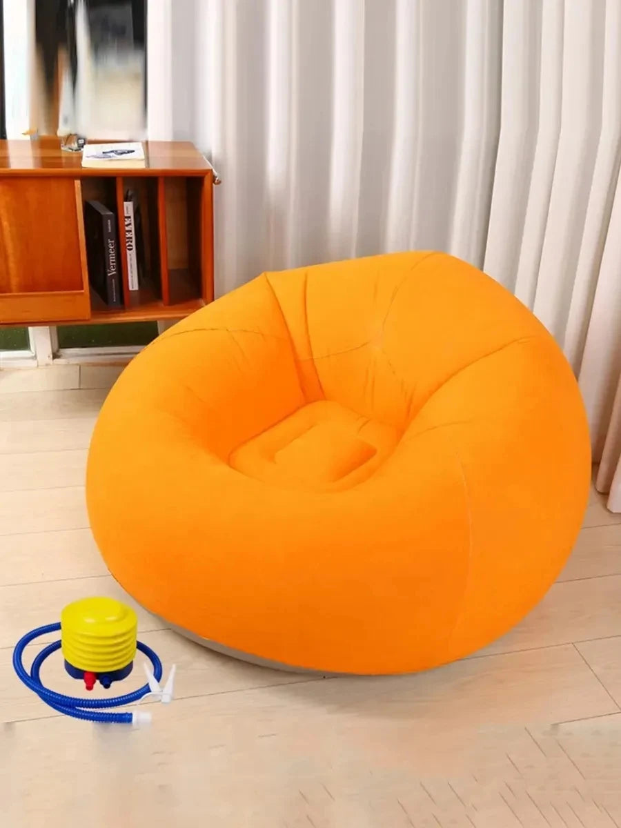 Orange inflatable lazy sofa with a hand pump on the floor